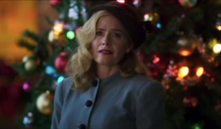 Greyhound Elizabeth Shue looks back wistfully in front of a Christmas tree