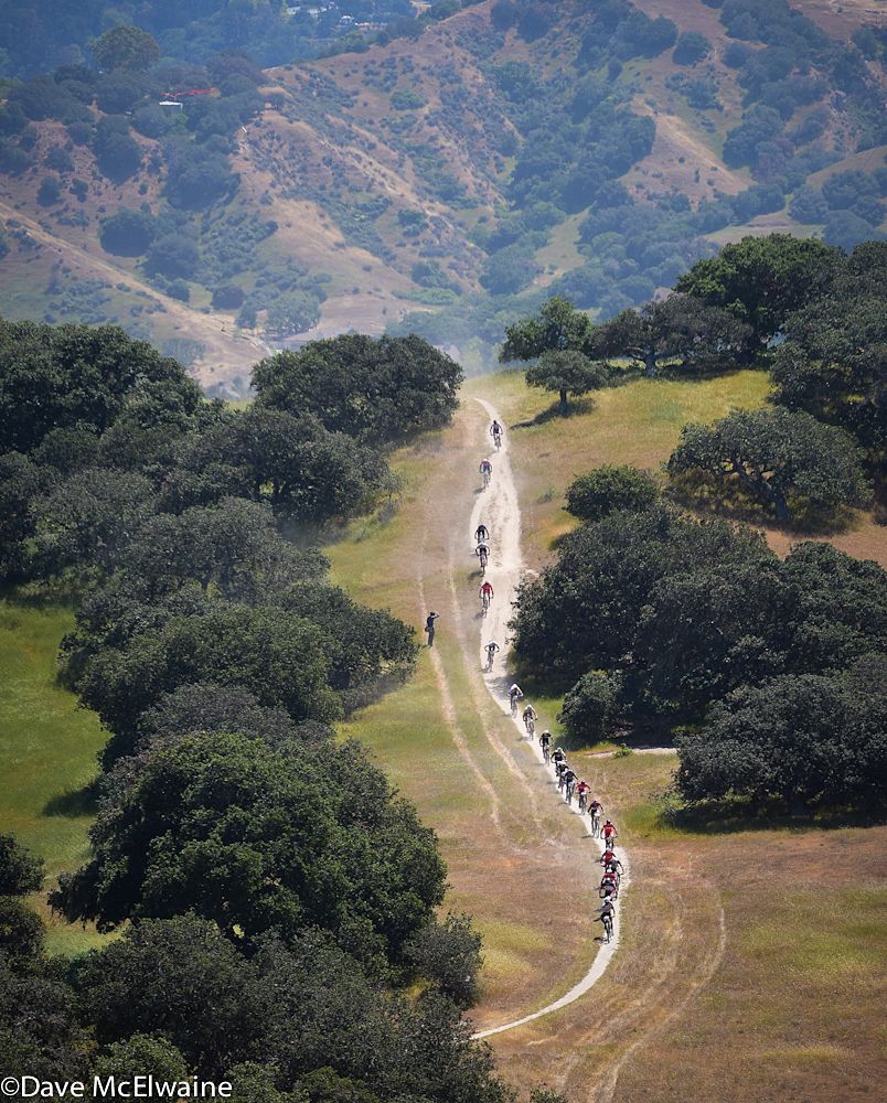 The leaders descend into a valley before starting the final climb back to the race track