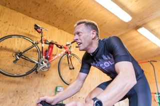 Male cyclist getting sweaty while riding hard indoors