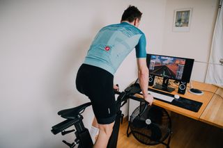 Image shows rider exercising indoors.
