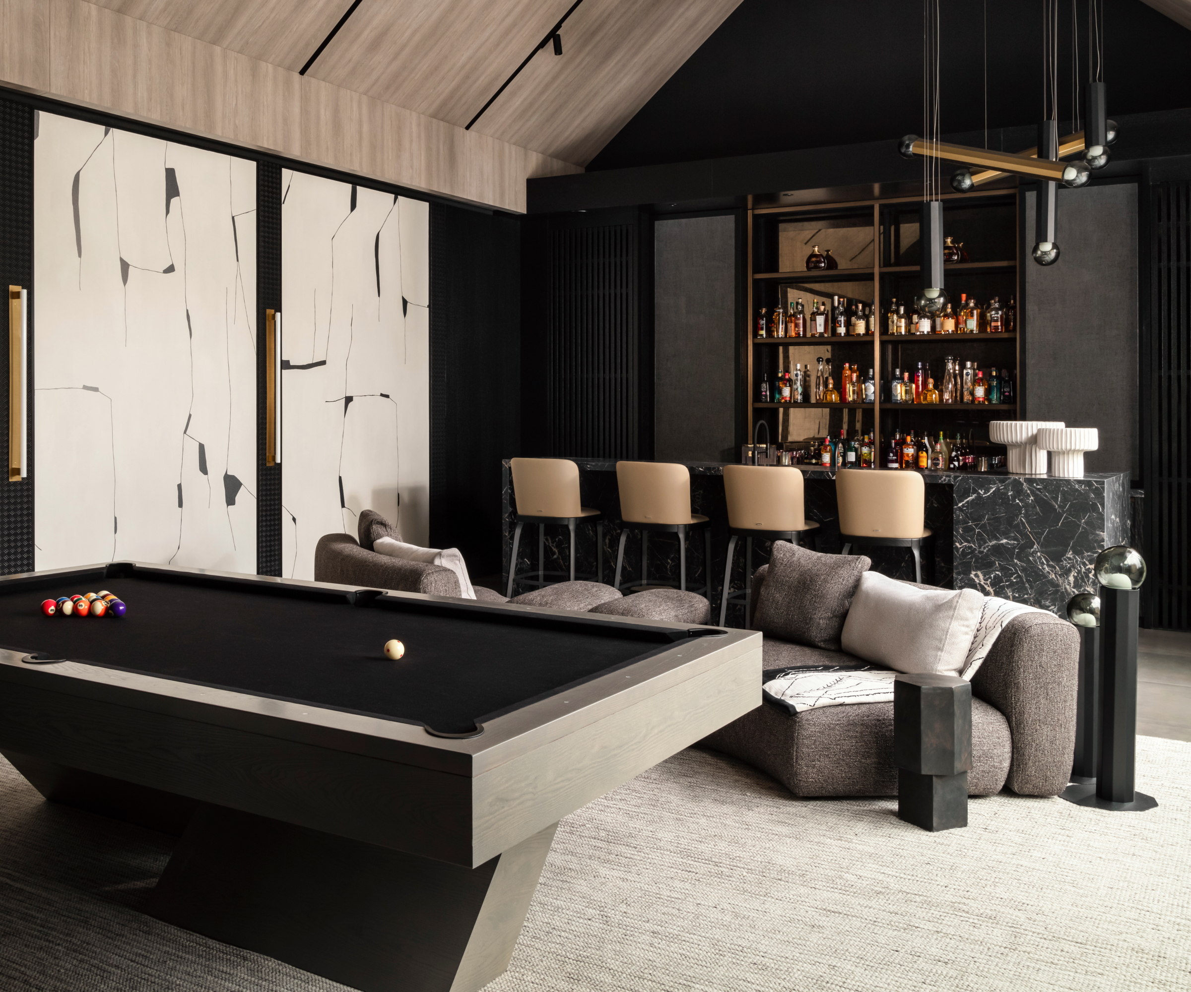 Black and white home bar with stools, low sofas and pool table