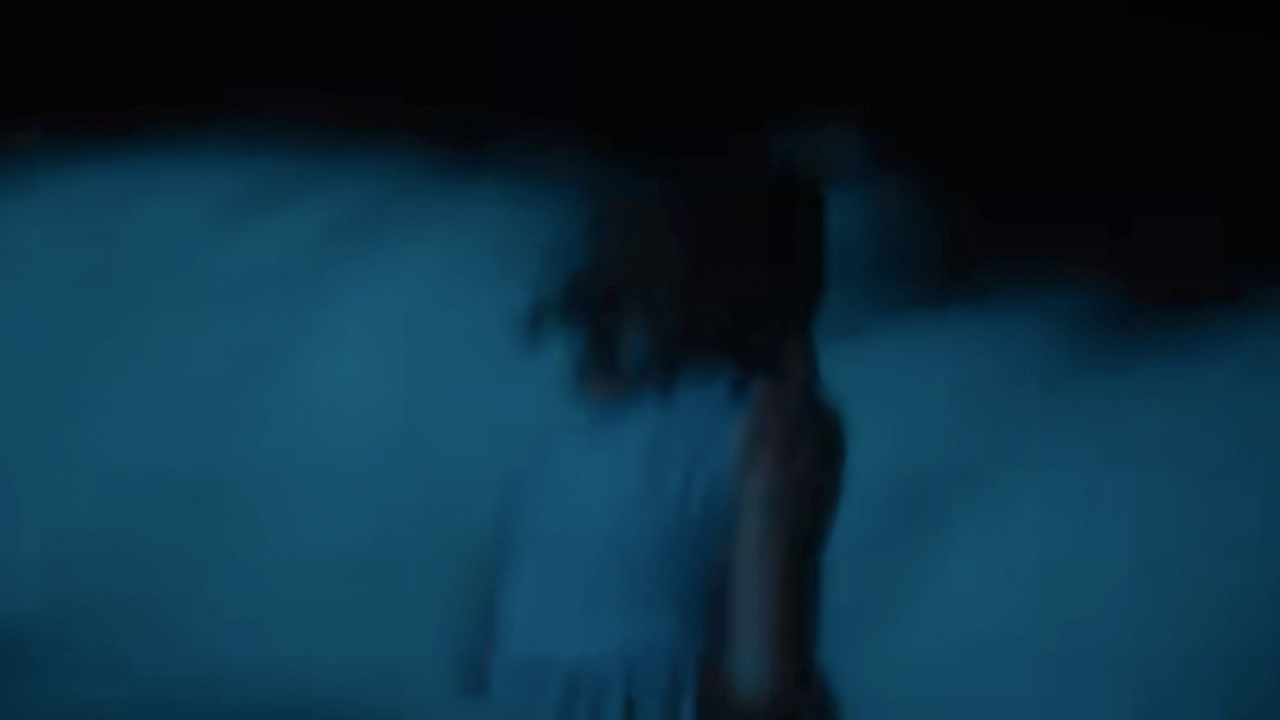 A haunting image of Rose Byrne running into the waves in If I Had Legs I'd Kick You