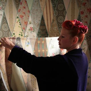 Escape to the Chateau Episode: Make Do and Mend. Angel Strawbridge hanging patterned fabric.