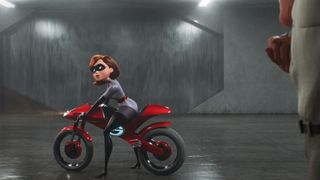 Elastigirl gets on a motorcycle in a garage in Incredibles 2