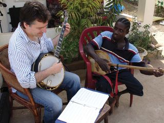 Fleck with Remi Jatta, who plays the akonting, a West African ancestor of the modern banjo.