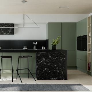 Tiles of Spain green kitchen with black marble accent