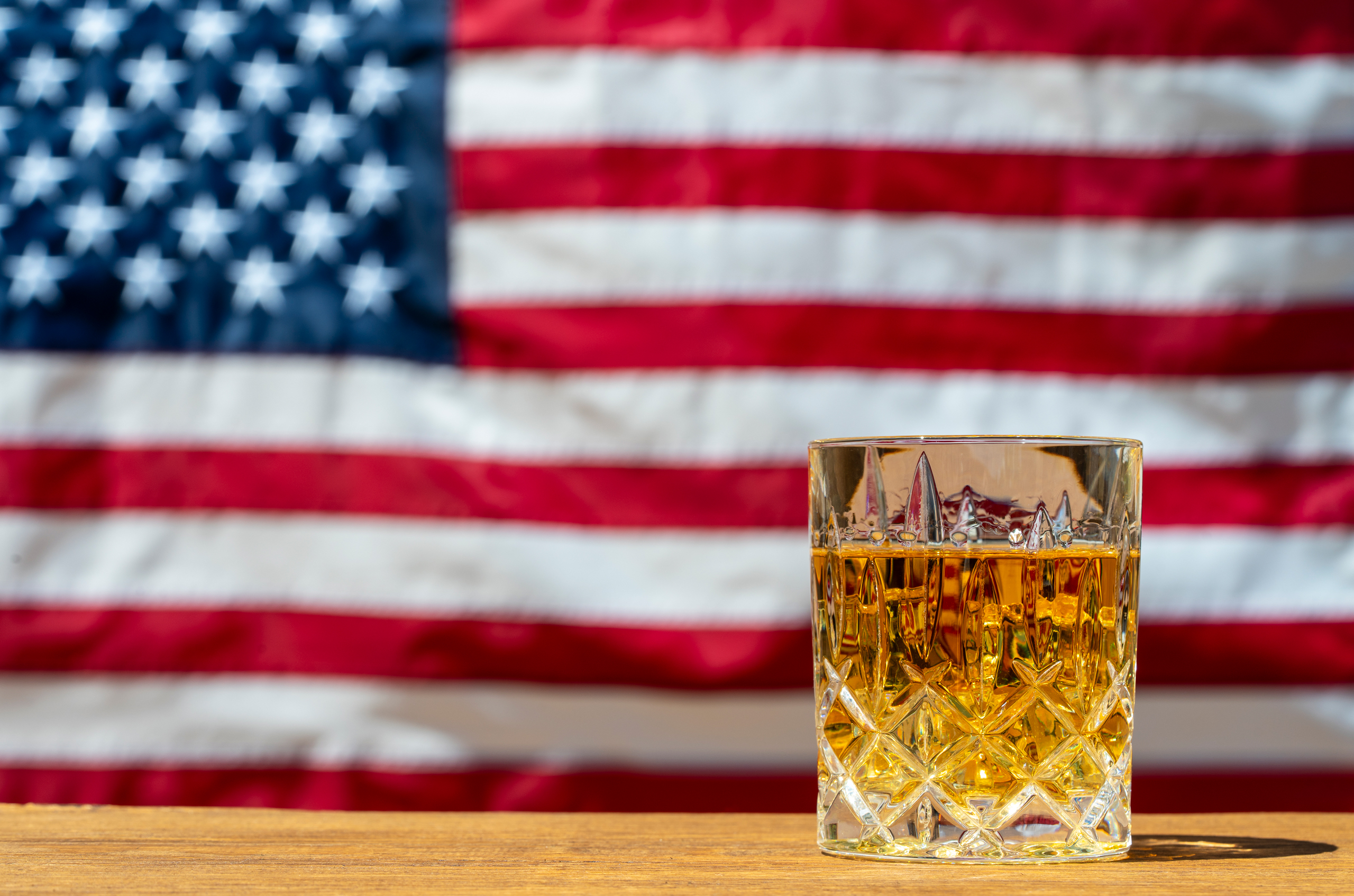 US whiskey in glass with US flag