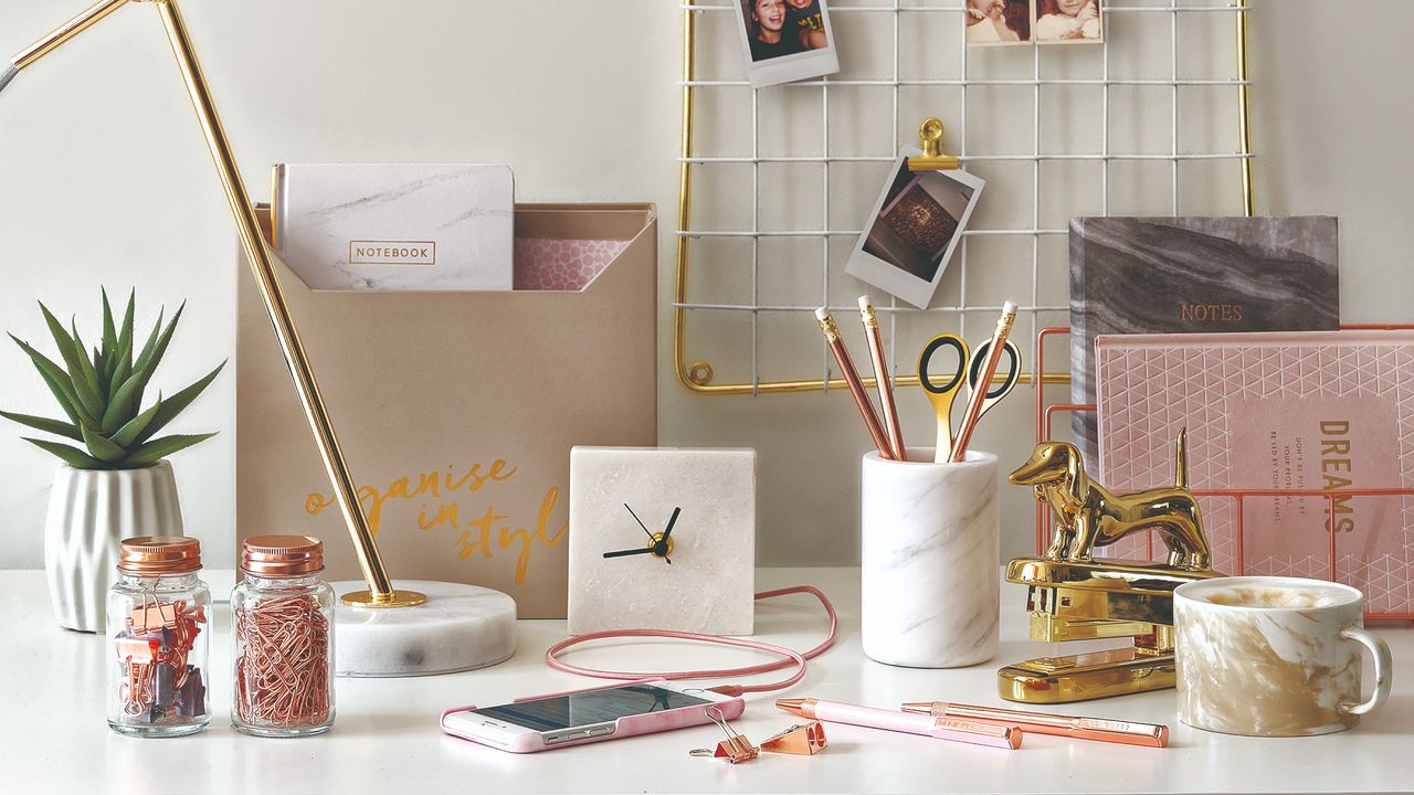 A home office desk with stationery items scattered