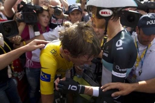Andy Schleck is comforted by his brother Frank after his defeat in the Grenoble time trial.