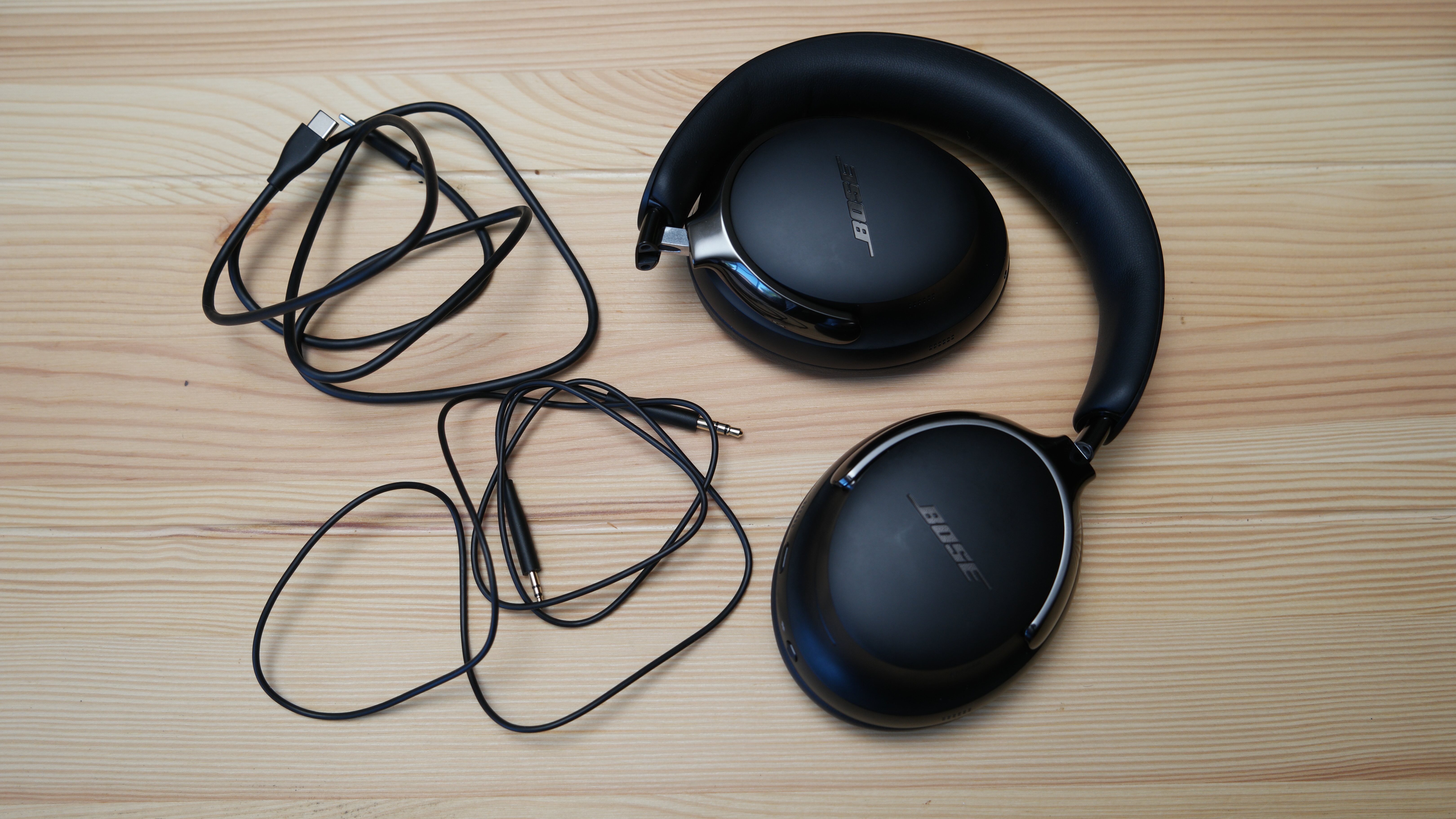 Bose QuietComfort Ultra Headphones (2nd Gen) next to the included accessories