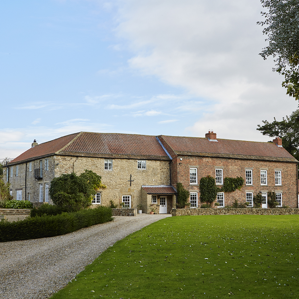 house exterior with driveway and grass lawn