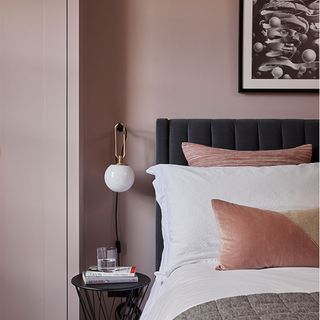 pink bedroom with grey bed designed cushions frame on wall