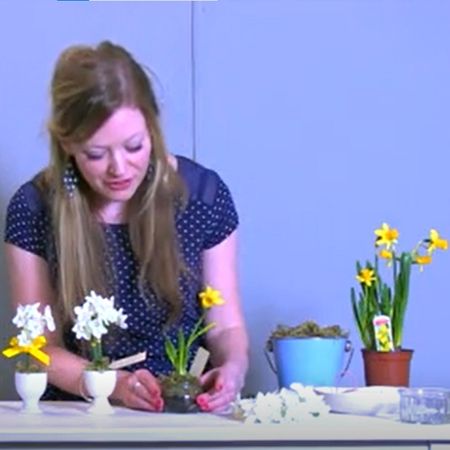 lady setting up flowers in pots