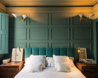 Green paneled bedroom with white and brass bedroom wall lighting ideas