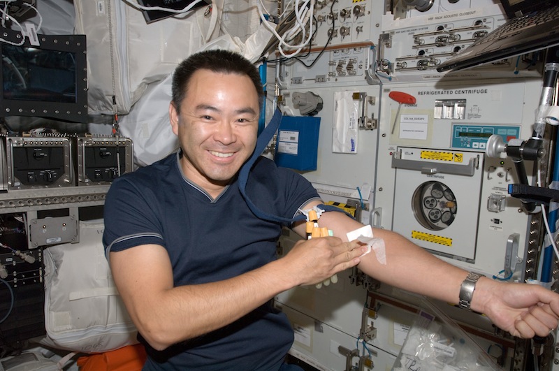 Astronaut taking a blood sample