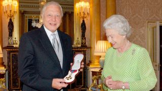 Britain's Queen Elizabeth II presents TV naturalist Sir David Attenborough with the Insignia of the Order of Merit, a personal award from the Queen recognising exceptional achievements in the advancement of arts, learning, literature and science at Buckingham Palace on June 10, 2005 in London.
