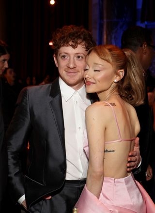 Ariana Grande attends the 2025 National Board of Review Gala at Cipriani 42nd Street on January 07, 2025 in New York City with ethan slater wearing a pink blackess dress and a beaded loewe squeeze bag