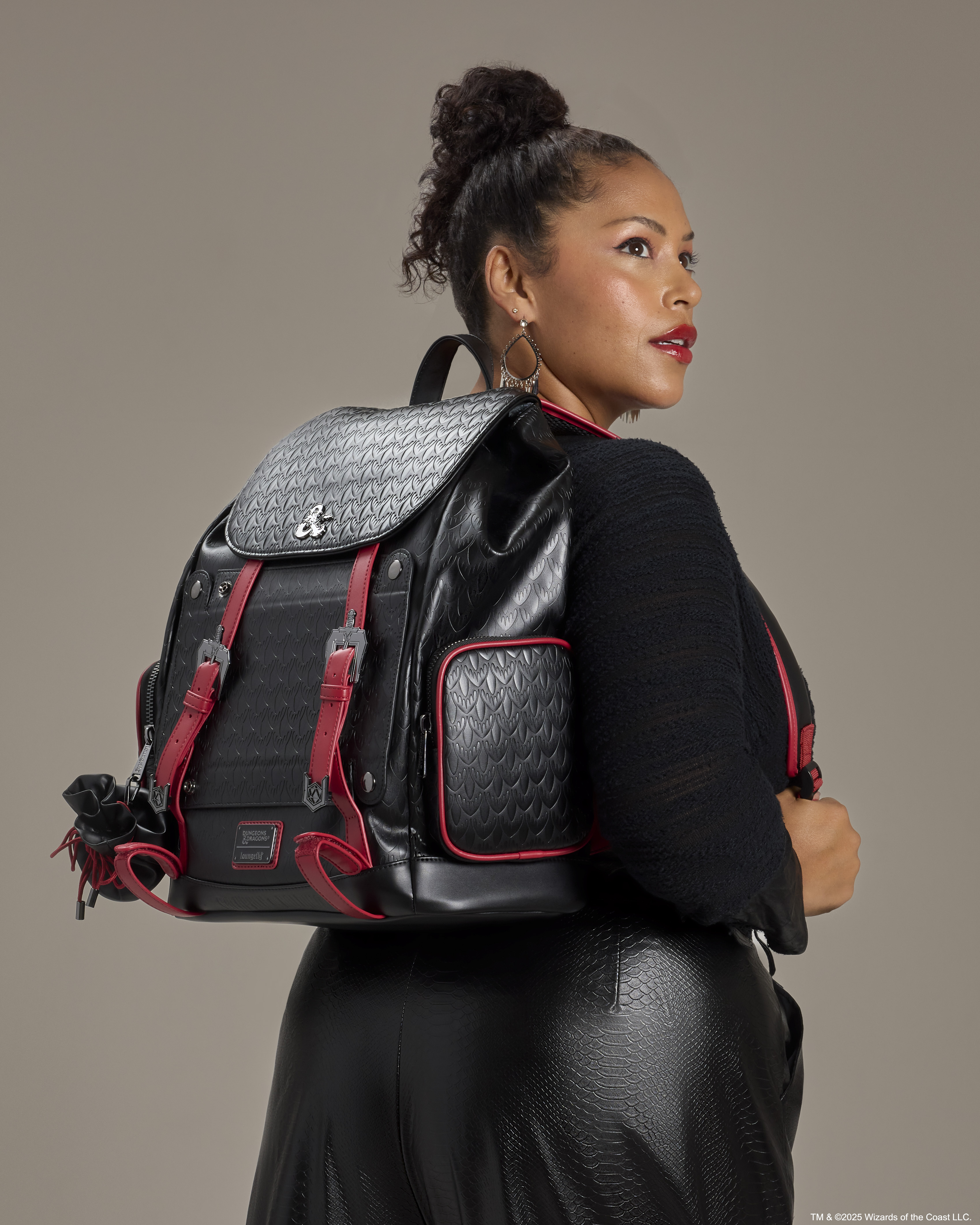A woman wearing the Loungefly D&D backpack looks off to the right of frame
