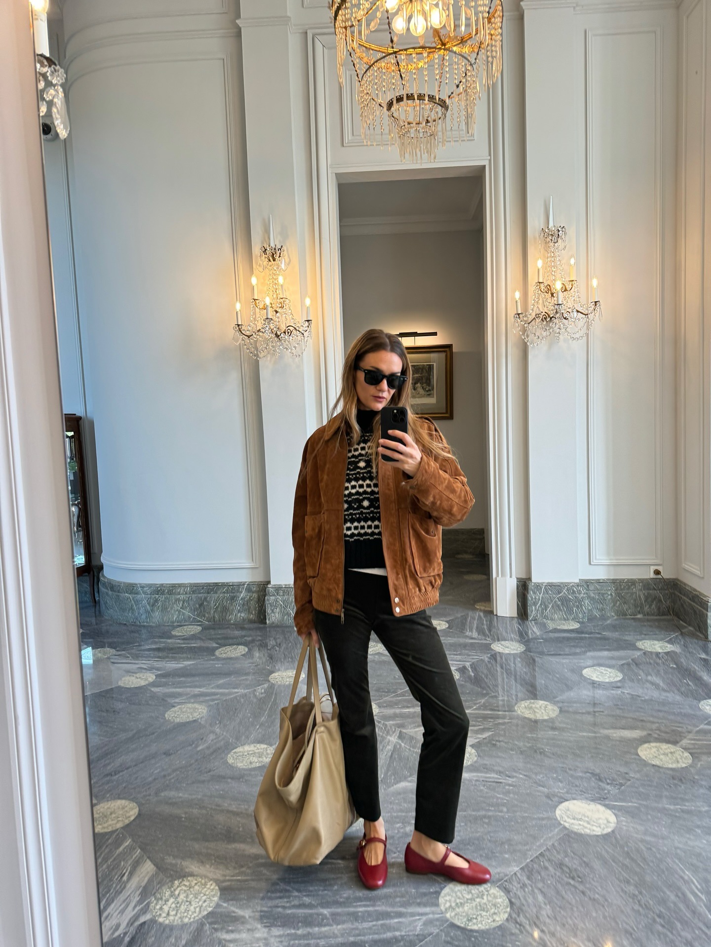 Influencer wearing black pants with red Mary Janes.