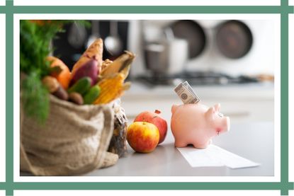 Piggy bank with money sitting next to a shopping bag with food