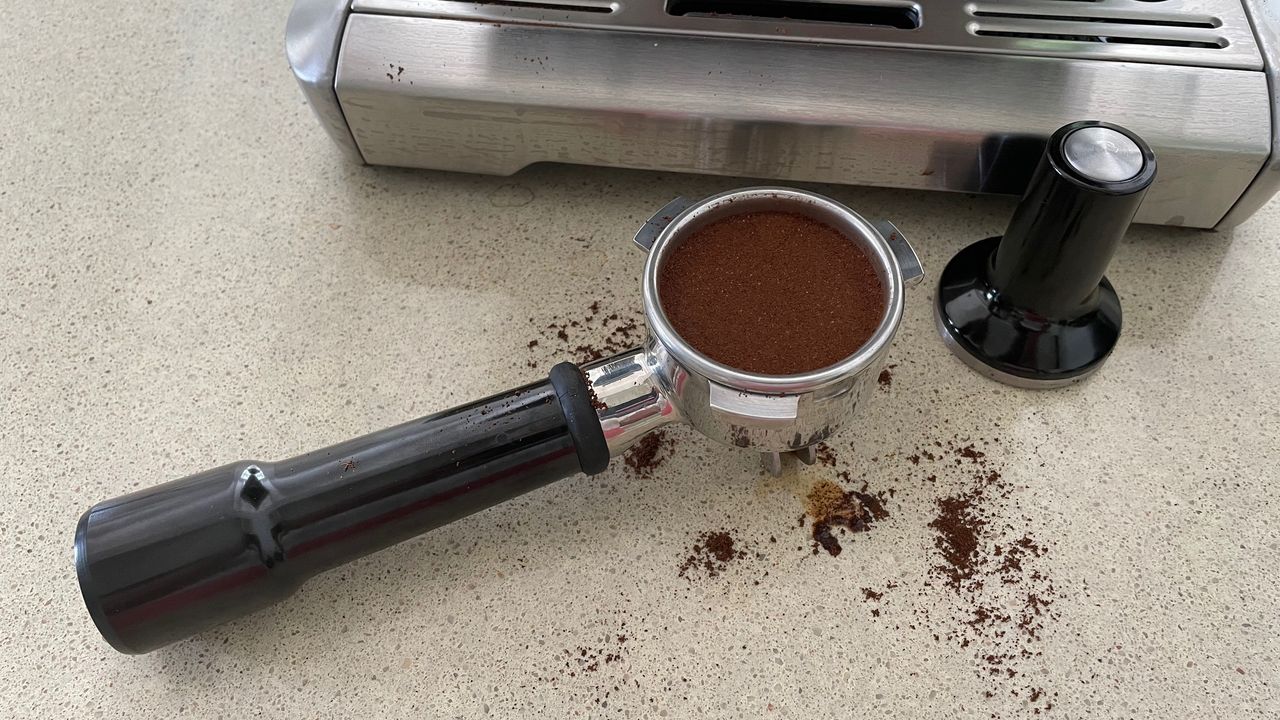 Breville Barista Express coffee maker portafilter with ground coffee
