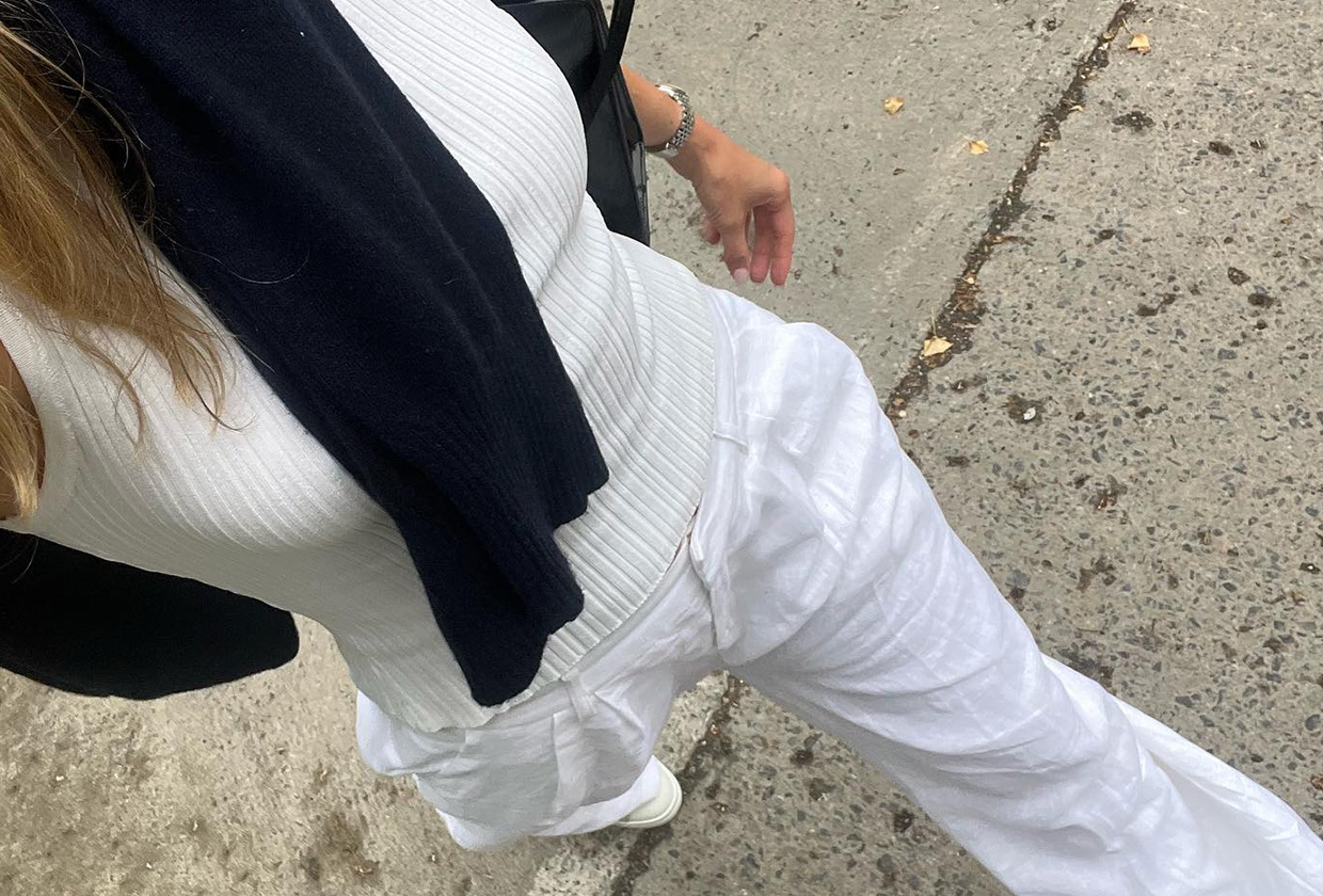 Eliza Huber wearing a white top and white linen pants.
