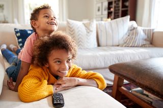 Siblings on a sofa