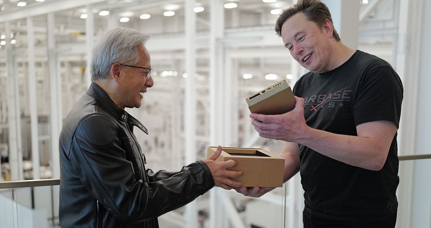 Nvidia CEO Jensen Huang handing Elon Musk the first DGX Spark mini supercomputer unit at SpaceX facility.
