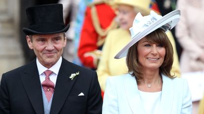Michael and Carole Middleton smile at the crowds following the marriage of Prince William, Duke of Cambridge and Catherine, Duchess of Cambridge at Westminster Abbey on April 29, 2011 in London, England