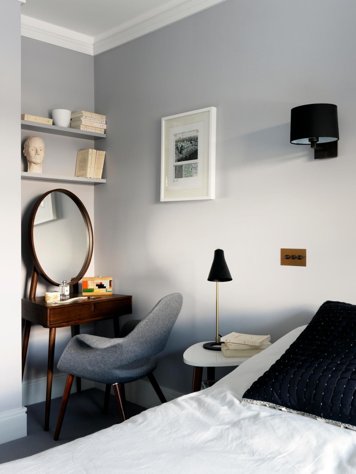 A small bedroom with overcrowded furniture