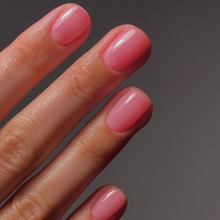 A close up of a pink jelly manicure