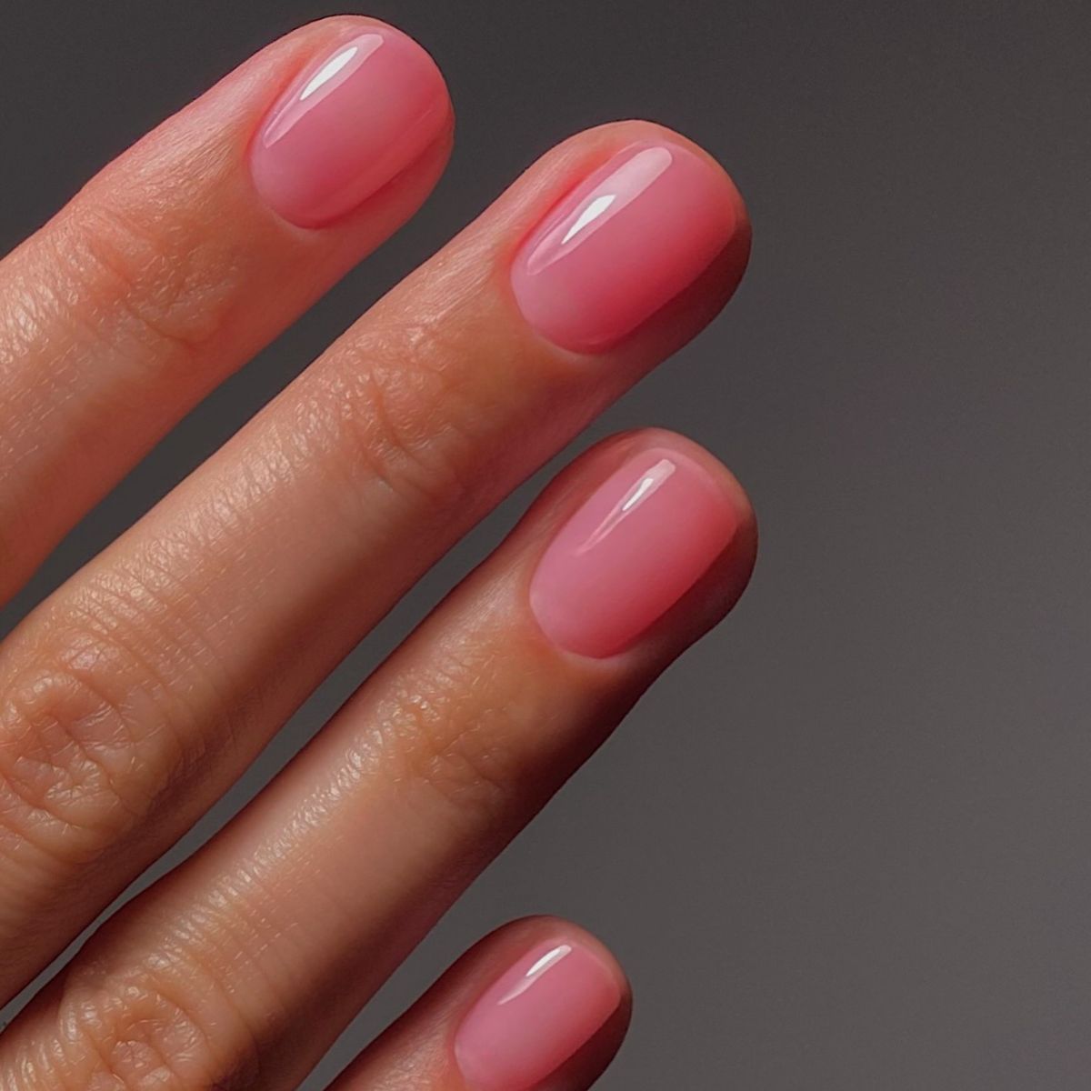 A close up of a pink jelly manicure