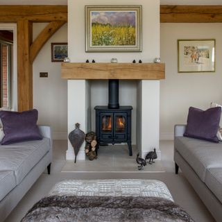 living room with wood burner and sofa