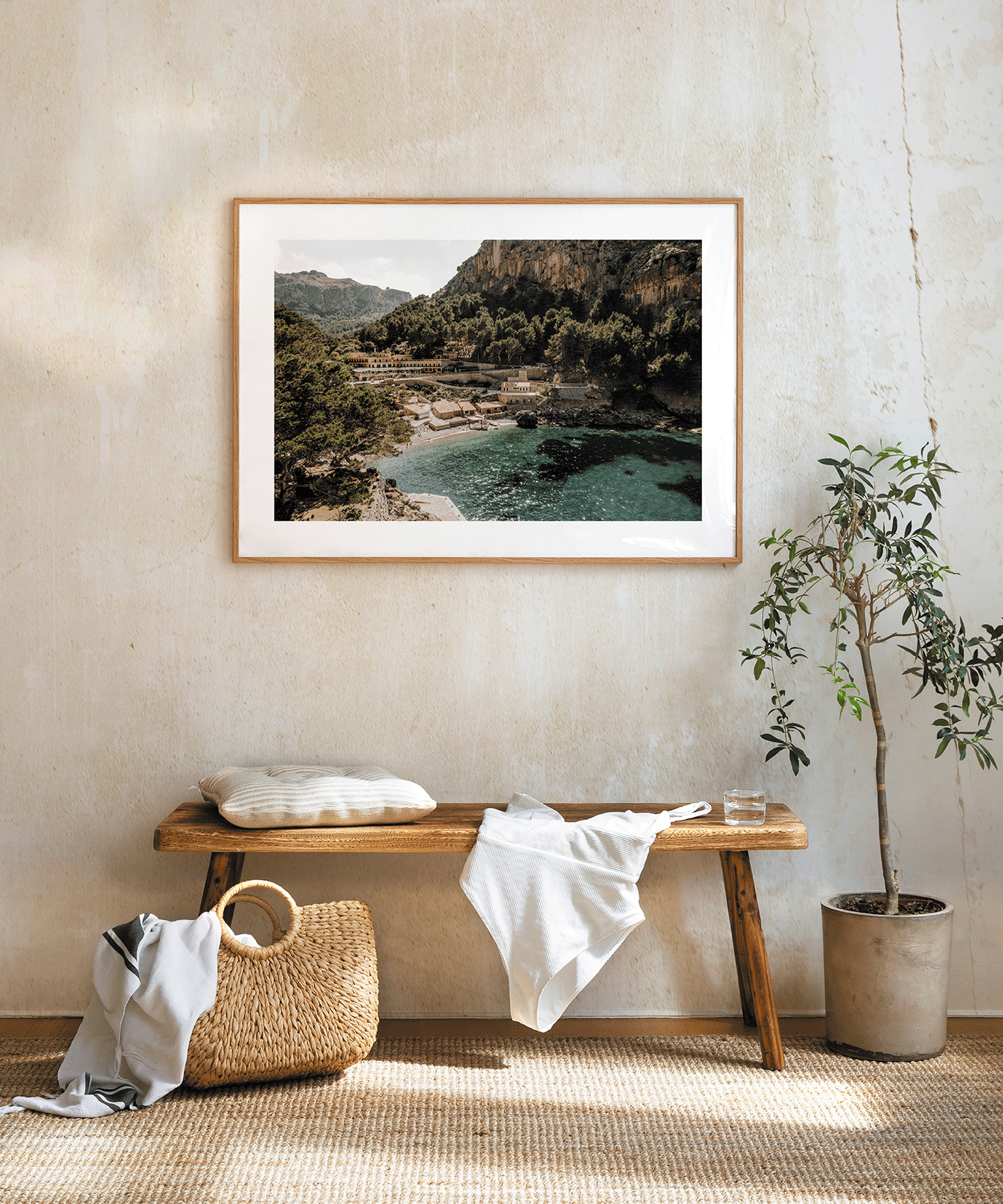 print of a nature scene along with a wooden side table and indoor tree