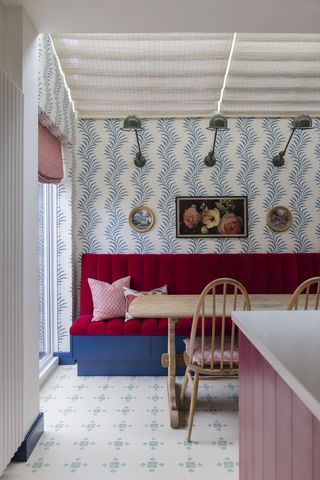 Dining nook with red seating and blue wallpaper