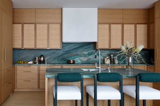 a timber kitchen with a blue green countertop
