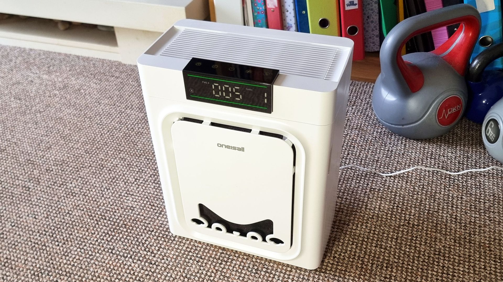 A picture of the Oneisall Pet Air Purifier standing in the middle of a living room