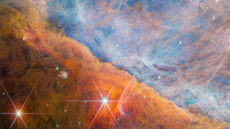 A beautiful starscape of orange and blue gas filled with twinkling stars