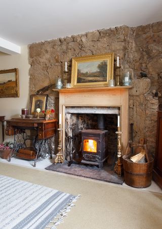 wood burning stove in wooden fireplace