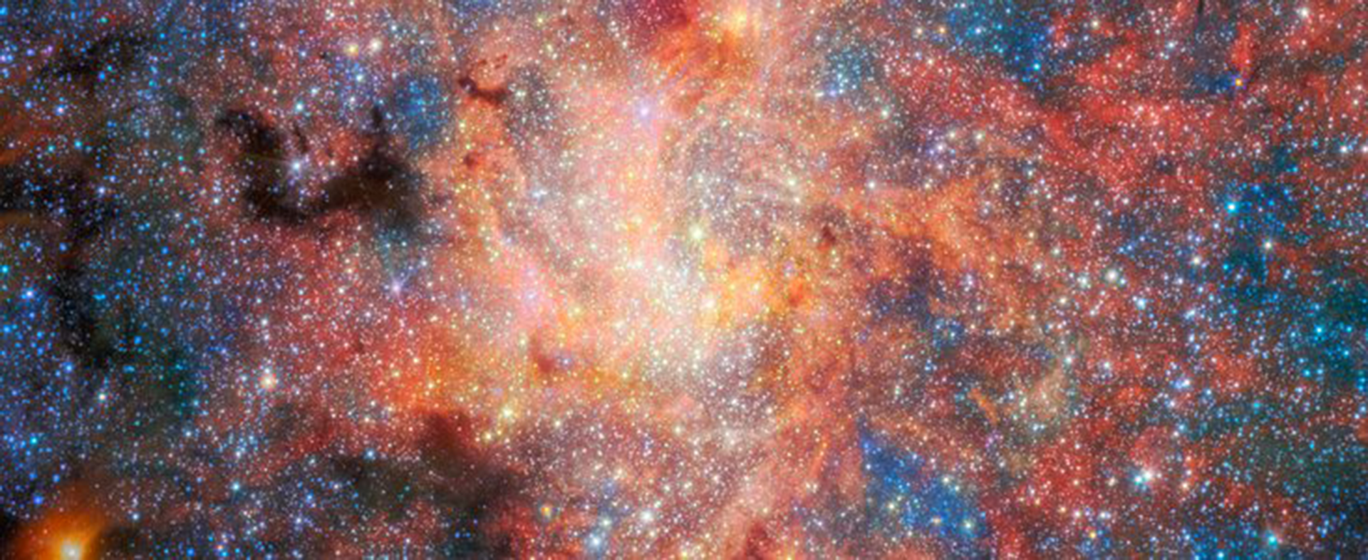 Swirls of red and blue gas are seen next to glowing stars in deep space