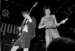 (L-R) Angus Young and Bon Scott of AC/DC