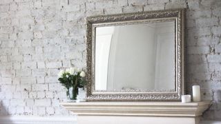 a mirror over a mantelpiece