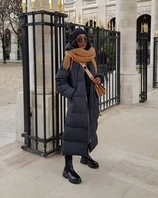 Influencer wearing black puffer coat, camel scarf, and black Chelsea boots.