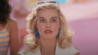 Margot Robbie as Barbie looking shocked.