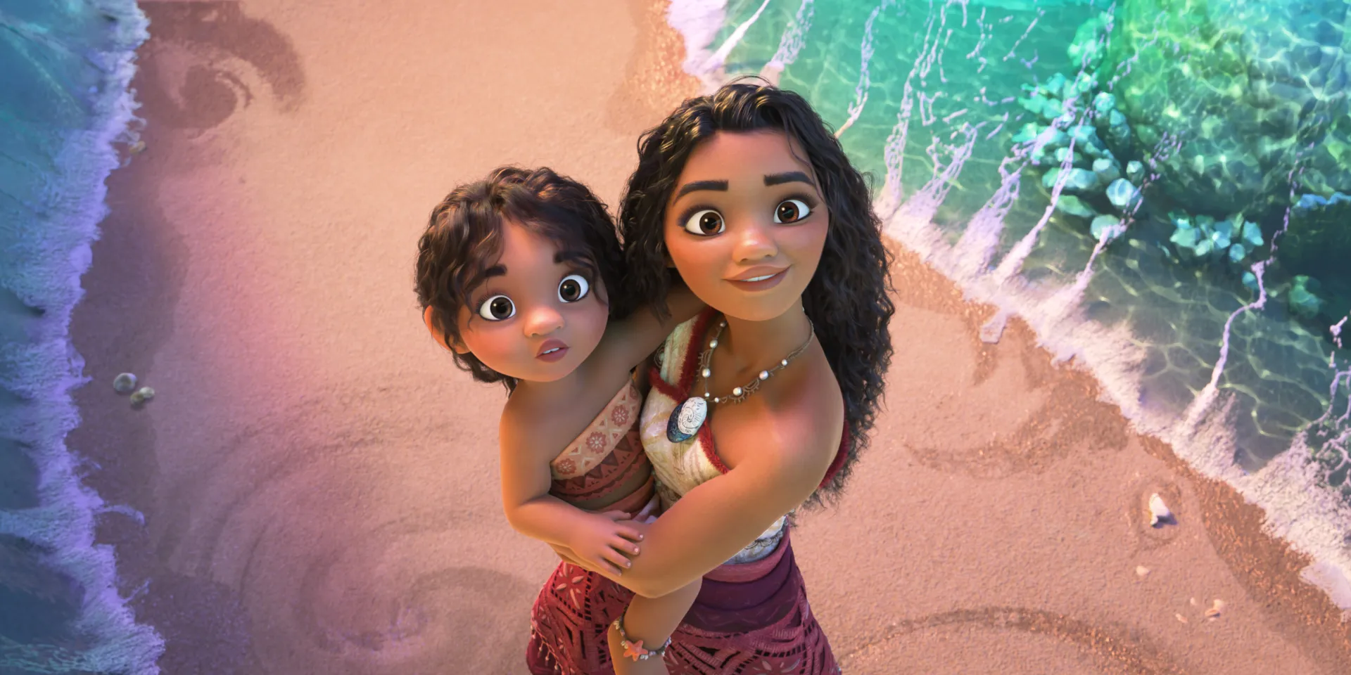 Moana holds her little sister in her arms and looks at the ocean