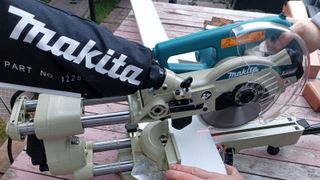 Makita LS0714LN 190mm Slide Compound Mitre Saw cutting white wood
