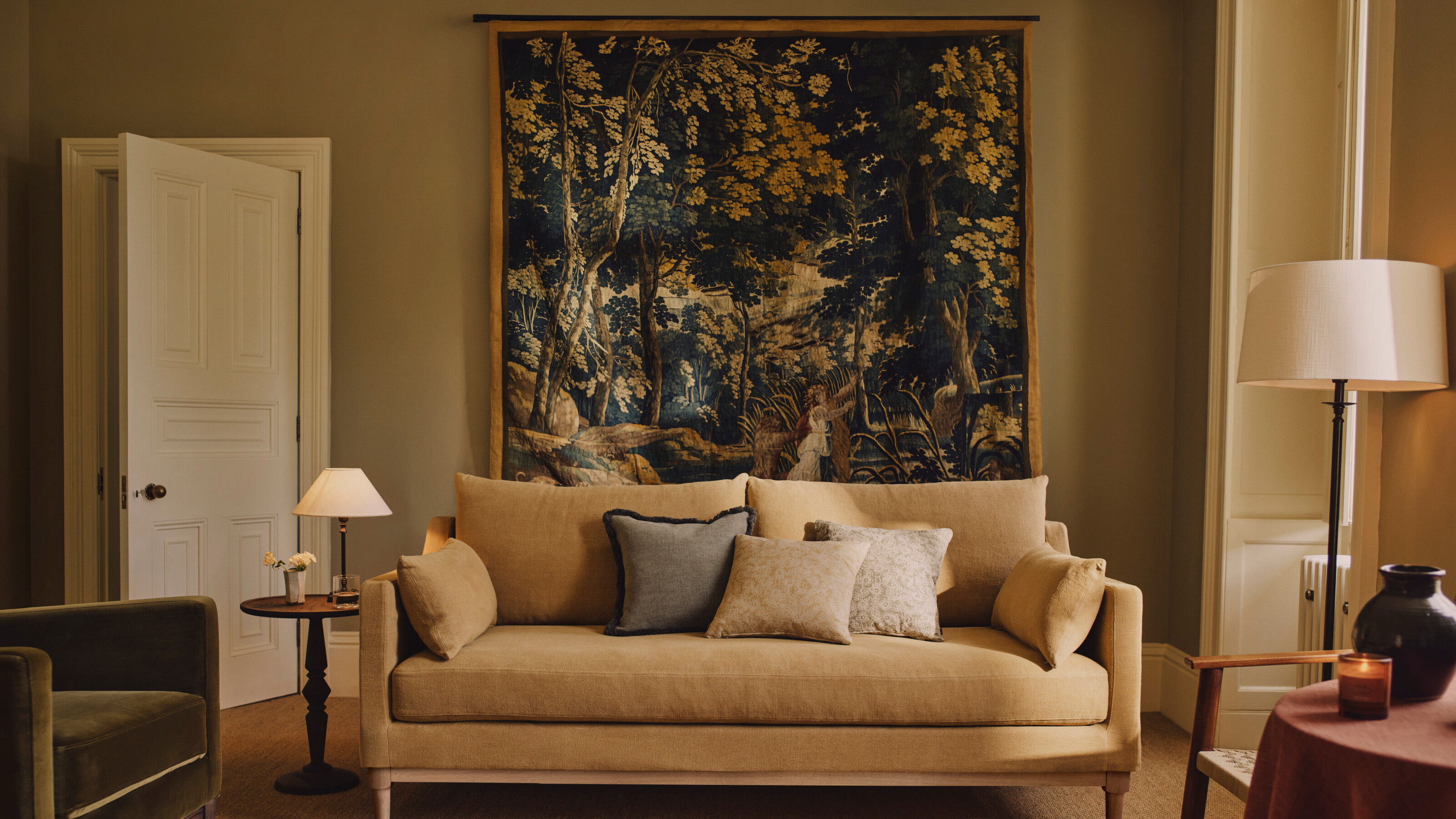 tapestry in neutral living room with beige walls and linen sofa