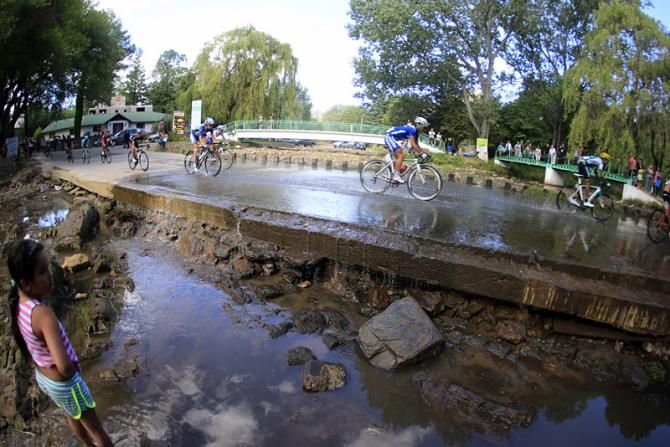 The Tour de San Luis peloton negotiates a water crossing during stage 5.