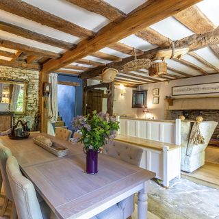 dining room with wooden beams and dining set