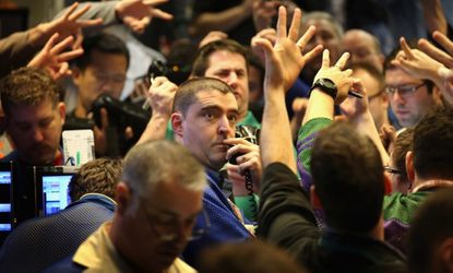 Traders signal offers in the Standard & Poor's 500 stock index options pit at the Chicago Board Options Exchange, March 20.